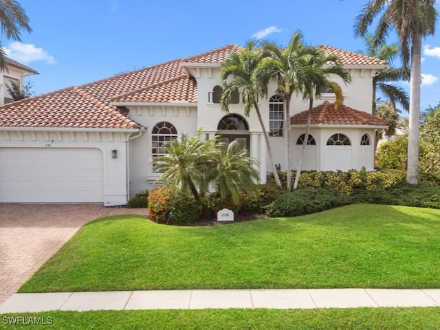 mediterranean / spanish home featuring a front lawn