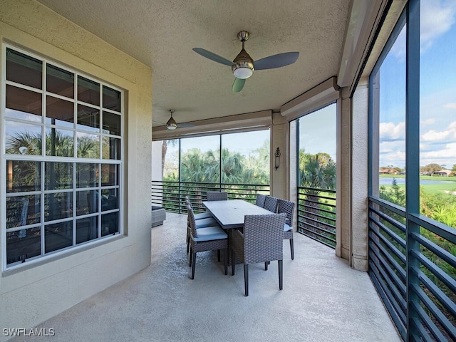 sunroom / solarium featuring ceiling fan