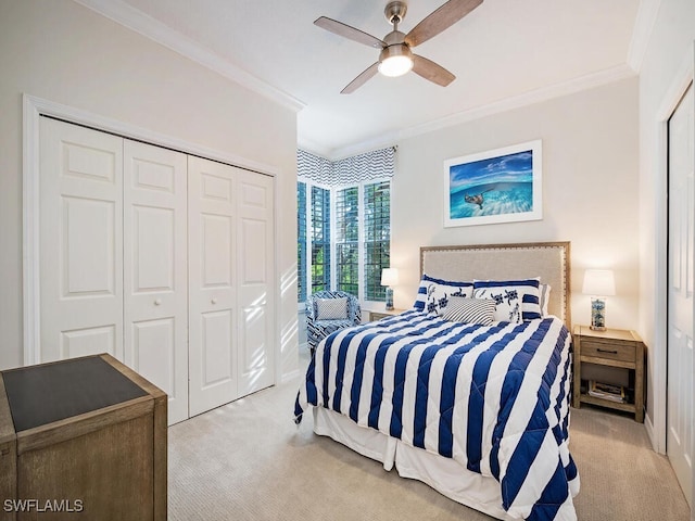 bedroom with light carpet, ornamental molding, a closet, and ceiling fan