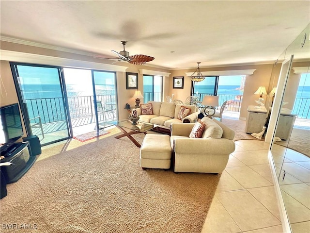 tiled living room featuring ceiling fan, a water view, and crown molding