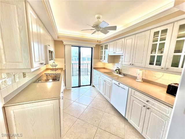 kitchen featuring ceiling fan, sink, tasteful backsplash, light tile patterned floors, and appliances with stainless steel finishes