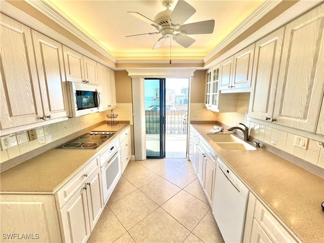 kitchen featuring white appliances, sink, light tile patterned floors, and tasteful backsplash