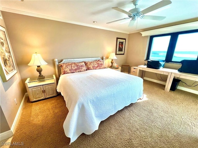 carpeted bedroom featuring ceiling fan and crown molding