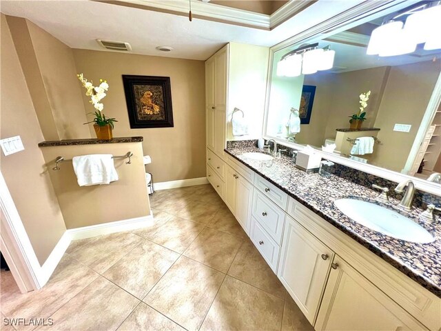 bathroom with tile patterned flooring, vanity, and toilet