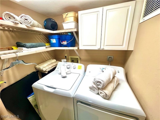 laundry area with cabinets and separate washer and dryer