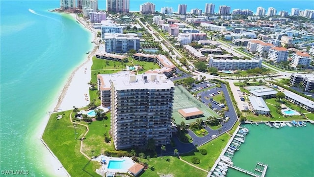 drone / aerial view featuring a water view and a view of the beach