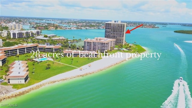 drone / aerial view with a water view and a beach view