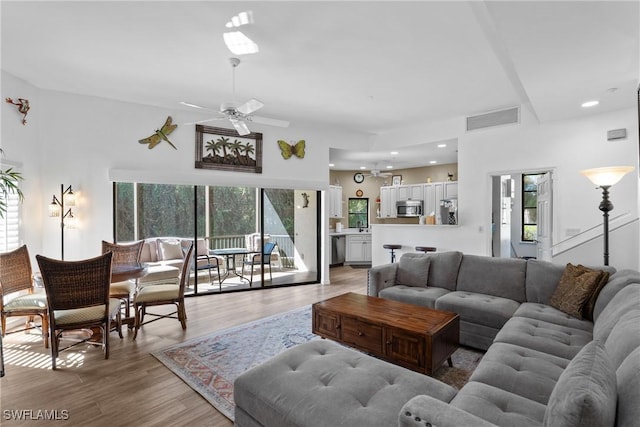 living room with hardwood / wood-style flooring and ceiling fan