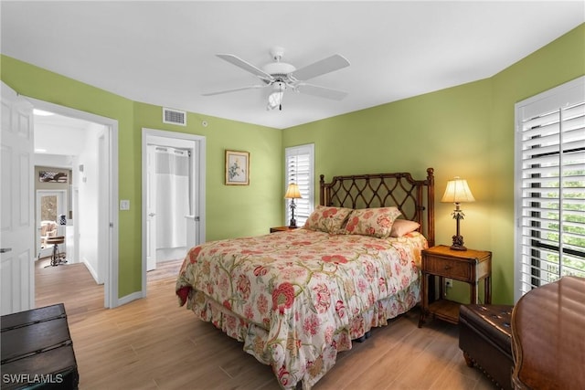 bedroom with ceiling fan and light hardwood / wood-style floors