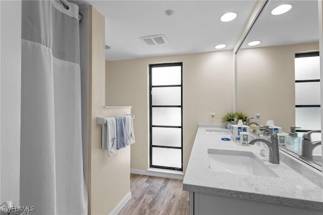 bathroom with a shower with curtain, vanity, and hardwood / wood-style floors