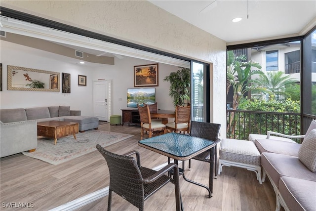 dining area featuring hardwood / wood-style flooring and expansive windows