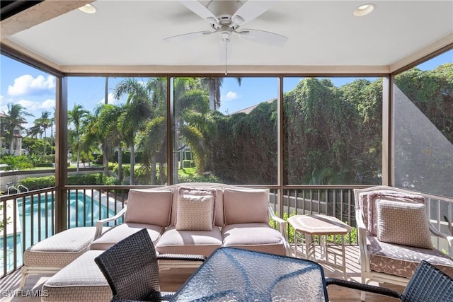 sunroom / solarium featuring ceiling fan