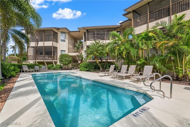 651 10th Ave S Unit C-651, Naples, FL 34102 - pool featuring a sunroom and a patio area