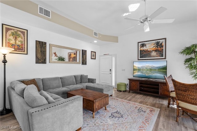 living room with hardwood / wood-style flooring and ceiling fan