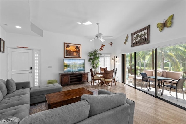 living room featuring ceiling fan and light hardwood / wood-style flooring