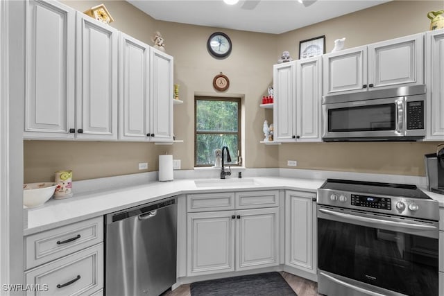 kitchen featuring white cabinetry, appliances with stainless steel finishes, and sink