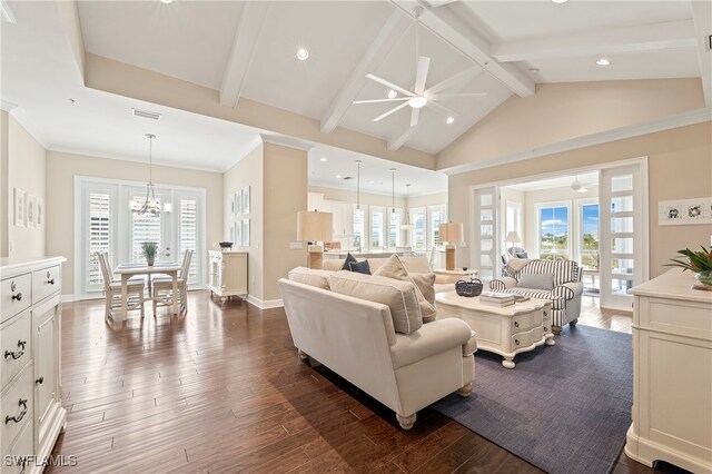 living room featuring a wealth of natural light, dark hardwood / wood-style floors, and ceiling fan with notable chandelier