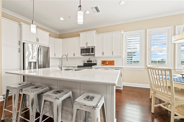 kitchen with sink, white cabinetry, decorative light fixtures, and stainless steel appliances