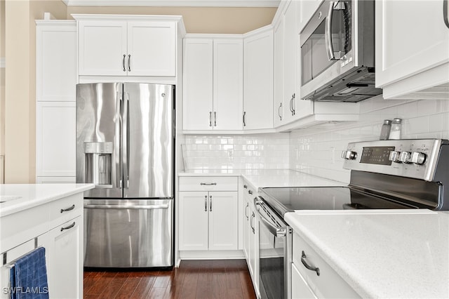 kitchen featuring stainless steel appliances, dark hardwood / wood-style floors, white cabinetry, and decorative backsplash