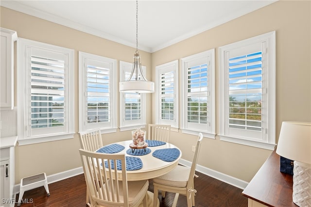 dining area featuring crown molding, a healthy amount of sunlight, and dark hardwood / wood-style floors