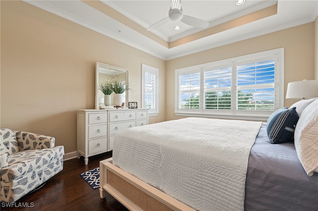 bedroom with crown molding, ceiling fan, dark hardwood / wood-style floors, and a tray ceiling