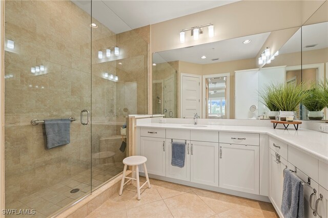 bathroom featuring an enclosed shower, vanity, and tile patterned floors