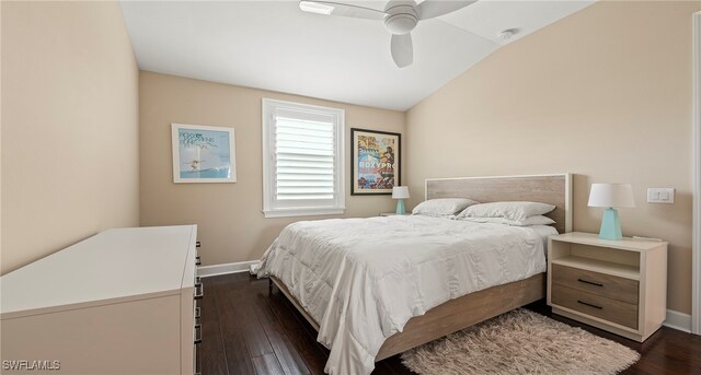 bedroom with vaulted ceiling, ceiling fan, and dark hardwood / wood-style flooring