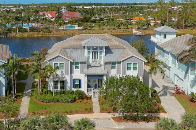 view of front facade with a water view and a balcony