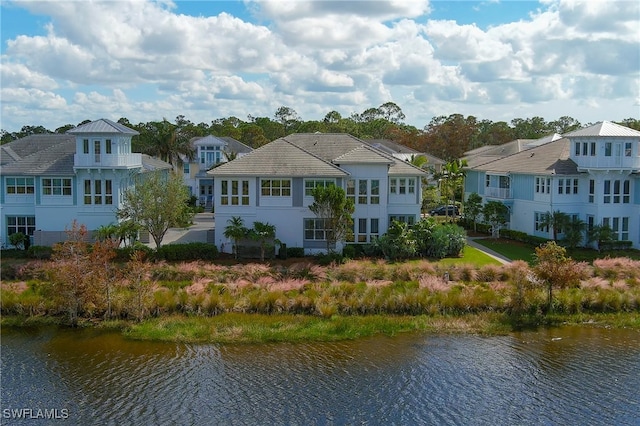 back of house featuring a balcony and a water view