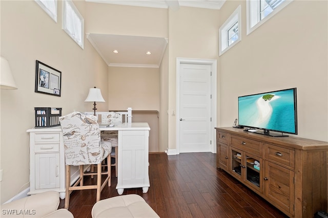 office area with dark wood-type flooring, a towering ceiling, and crown molding