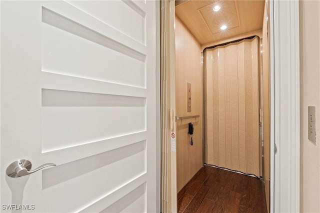 interior space featuring dark wood-type flooring and elevator