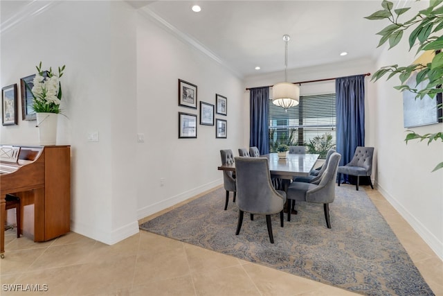 tiled dining area featuring crown molding