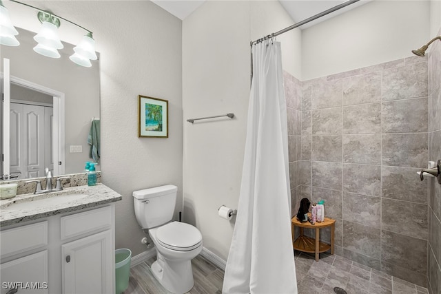 bathroom featuring vanity, toilet, and curtained shower