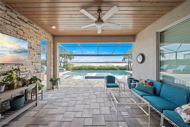 view of patio featuring outdoor lounge area, ceiling fan, and a lanai