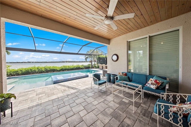 view of patio / terrace featuring an outdoor living space, a water view, ceiling fan, and a lanai