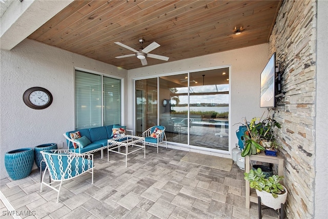 view of patio featuring an outdoor living space and ceiling fan