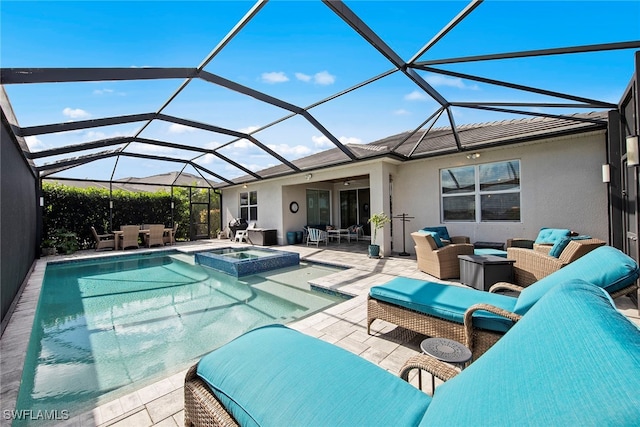 view of pool with a lanai, an in ground hot tub, a patio, and an outdoor hangout area