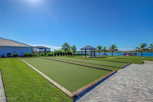 view of community with a gazebo, a lawn, and a water view