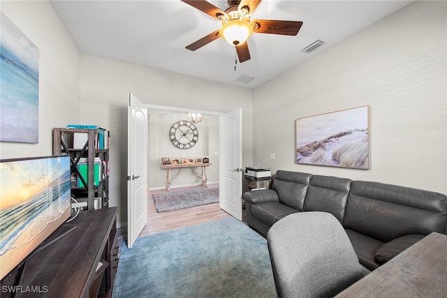 living room featuring ceiling fan and light wood-type flooring