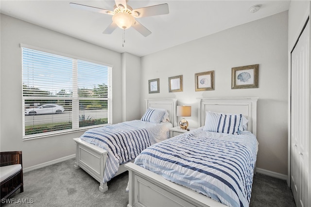 carpeted bedroom featuring a closet and ceiling fan