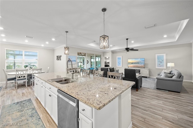 kitchen with white cabinetry, sink, pendant lighting, a center island with sink, and dishwasher