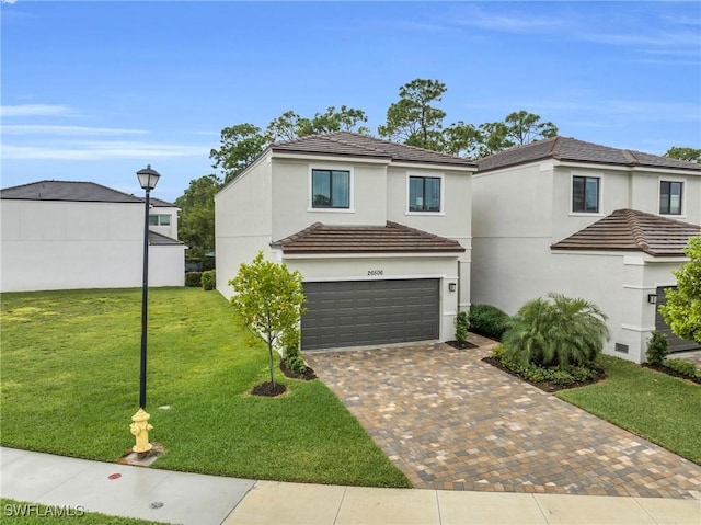 26506 Bonita Fairways Blvd, Bonita Springs, FL 34135 - view of front of home featuring an attached garage, decorative driveway, a front lawn, stucco siding, and a tiled roof