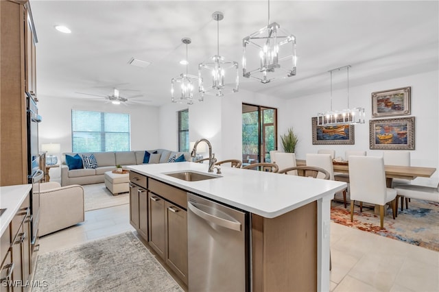 kitchen with stainless steel appliances, plenty of natural light, sink, and a kitchen island with sink