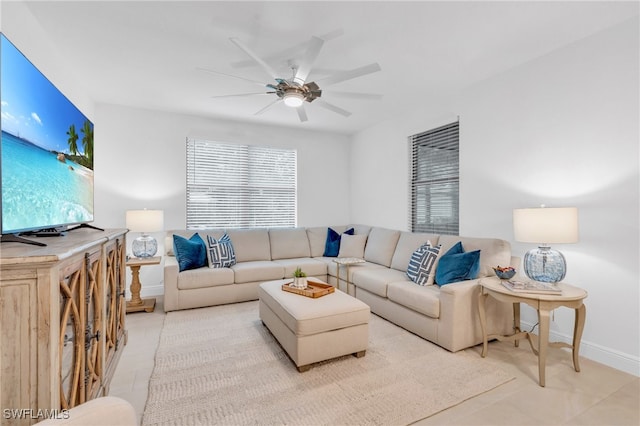 living room with ceiling fan and light tile patterned floors