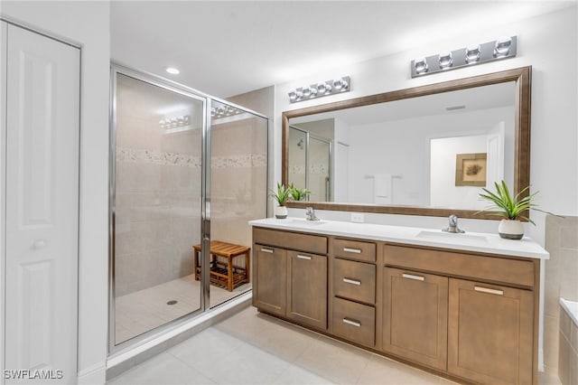 bathroom featuring tile patterned flooring, vanity, and an enclosed shower