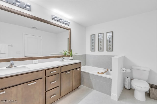 bathroom featuring vanity, tiled bath, tile patterned floors, and toilet