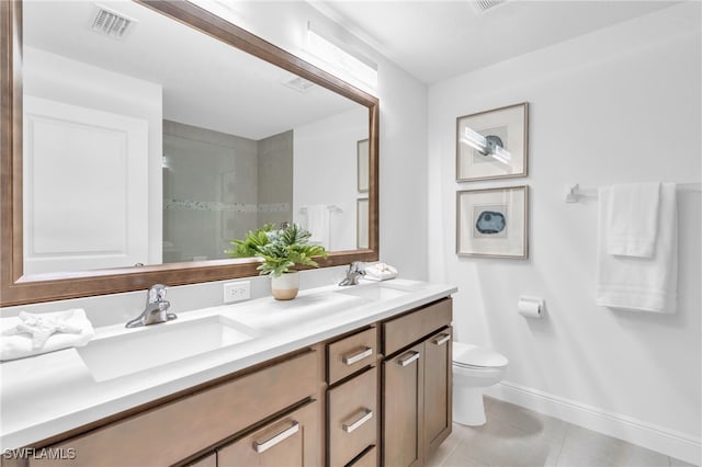 bathroom featuring vanity, tile patterned flooring, and toilet