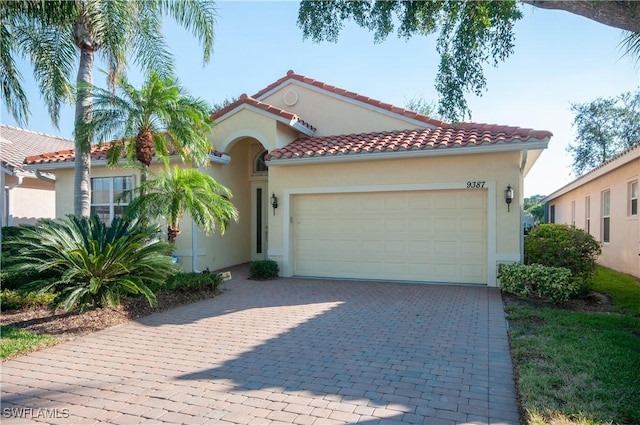 mediterranean / spanish-style home with a garage