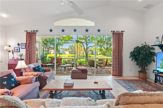 tiled living room featuring ceiling fan and vaulted ceiling