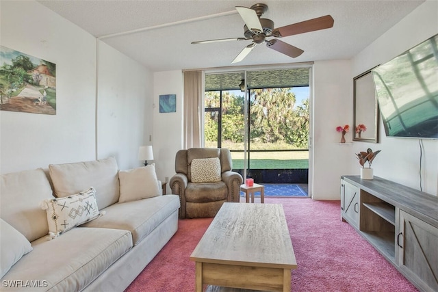 carpeted living room featuring ceiling fan and a textured ceiling